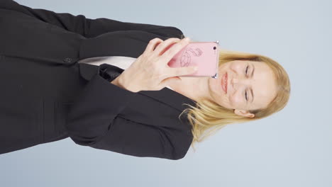 Vertical-video-of-Video-of-business-woman-making-video-call-on-phone.